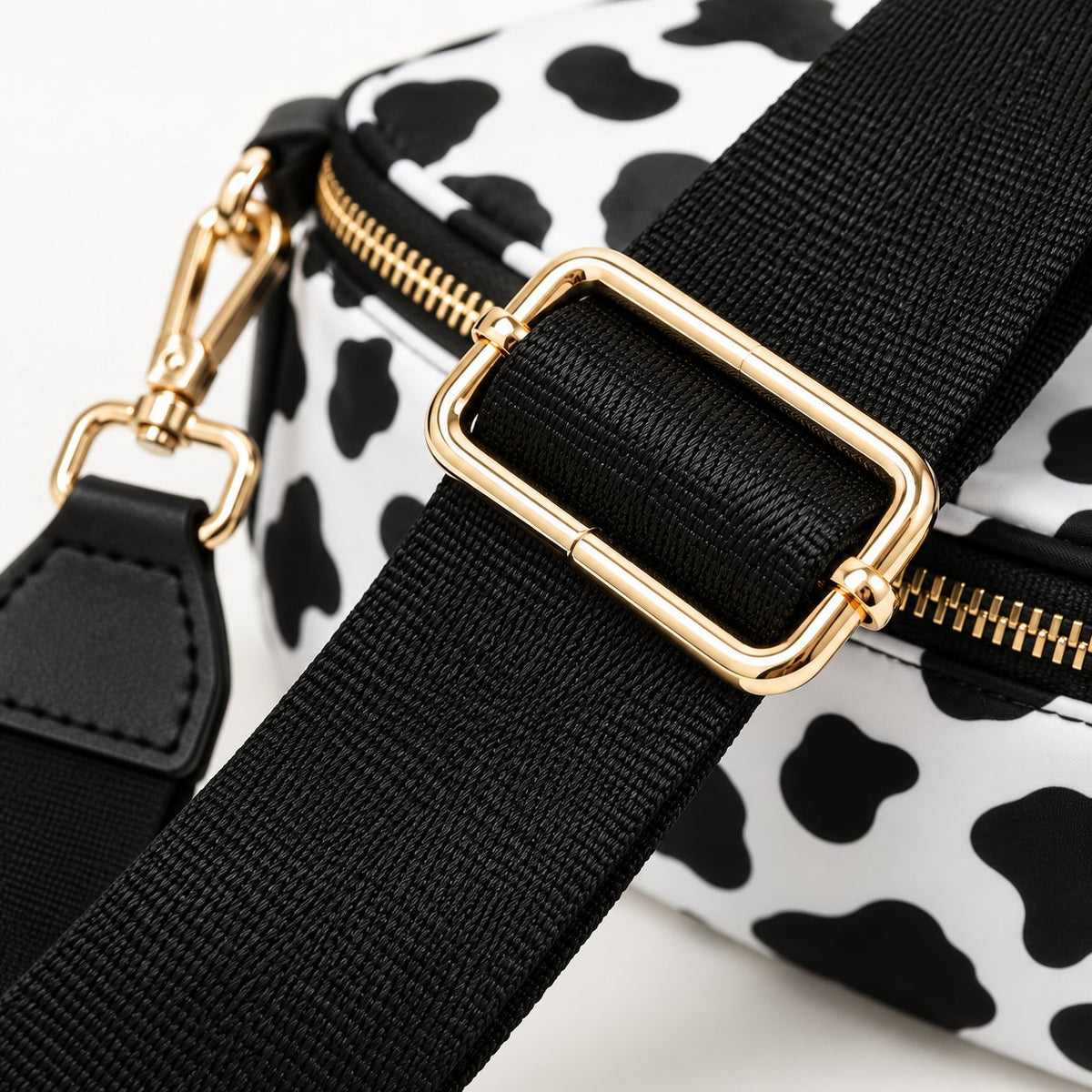Macro detail of the ZOCOIFY crossbody bag black woven strap and gold-tone adjustable buckle